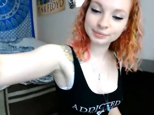 Redhead is removing her clothes