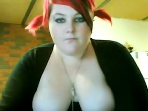 Busty redhead BBW shows off her boobs